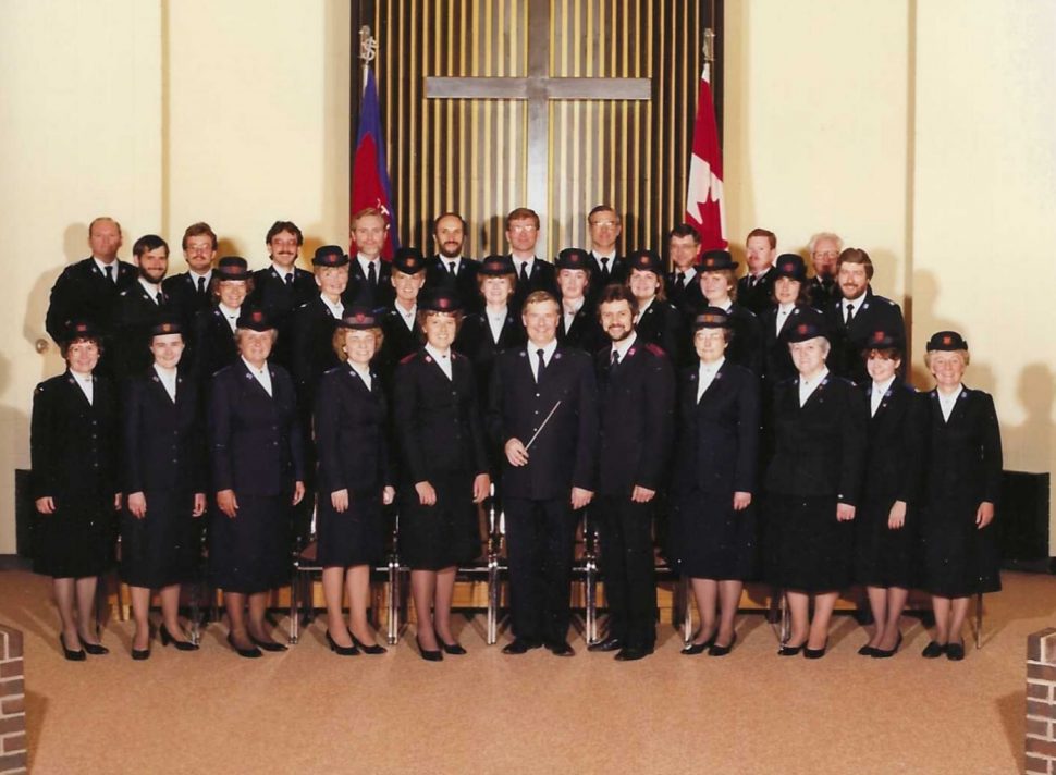 Group of singers in uniform pose for a photo
